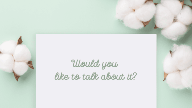 An image reflecting a card asking "Would you like to talk about it" with a soft mint green background and flowers.